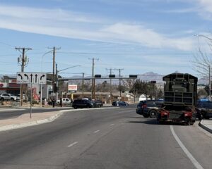 Police vehicles blocking an intersection.