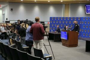 Chief Story speaking to news reporters in Council Chambers.