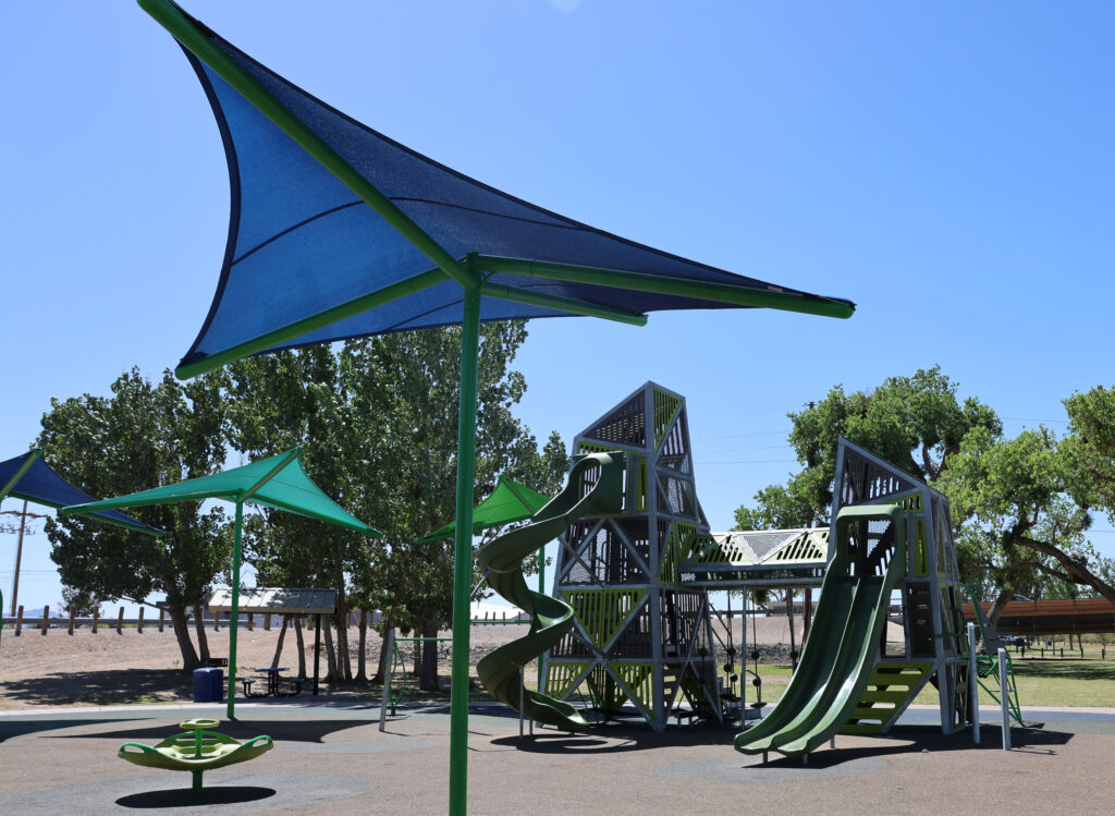 Close up of playground with structures at La Llorona Park over play equipment and soft surface.