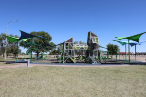 Full Playground with structures at La Llorona Park over play equipment and soft surface.